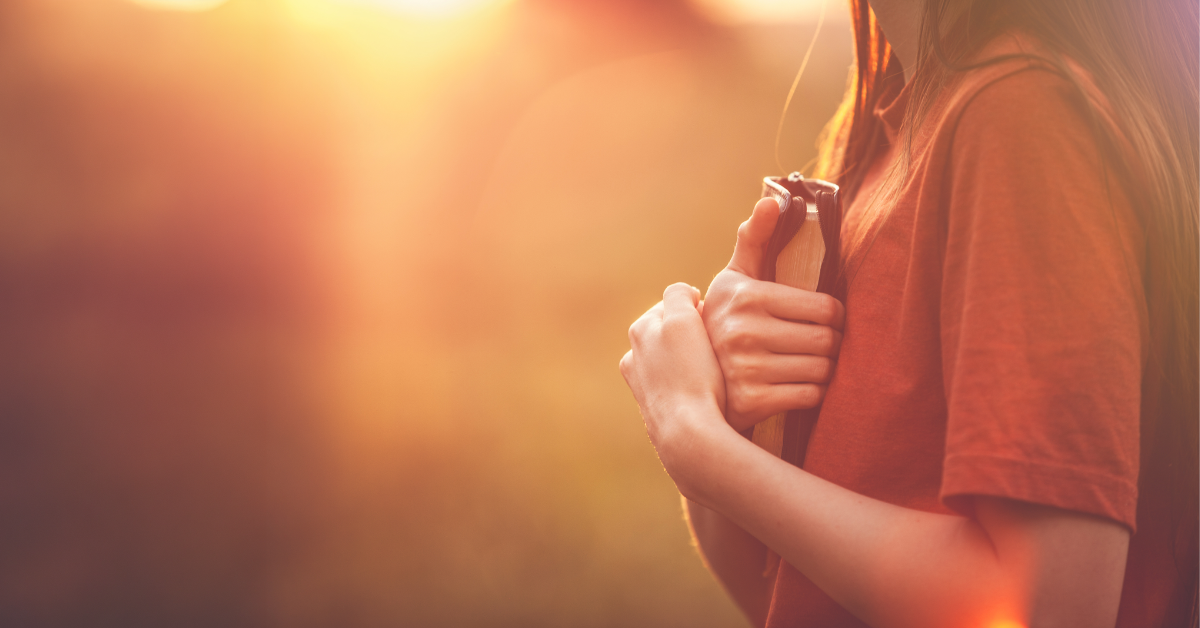 En kvinna håller om en Bibel.